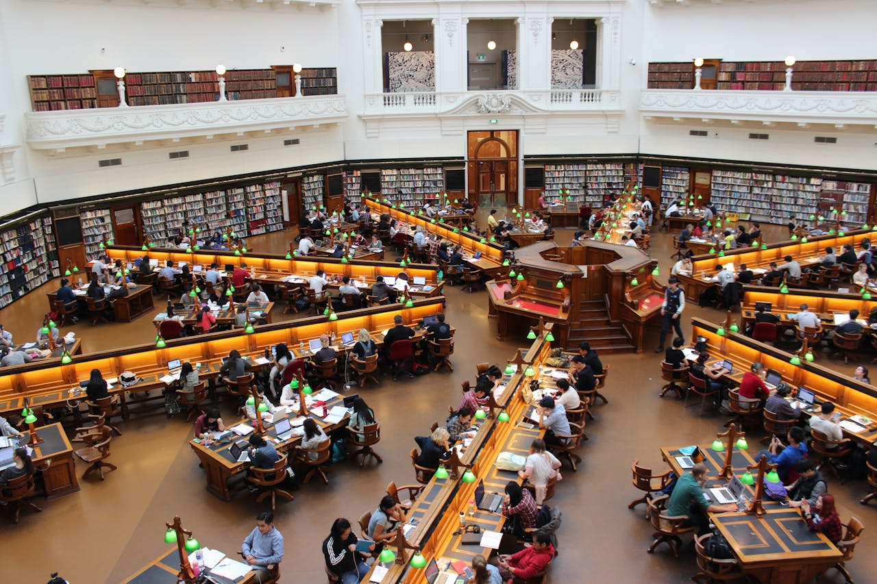 Aerial view of a bustling study hall in a university library with students studying.